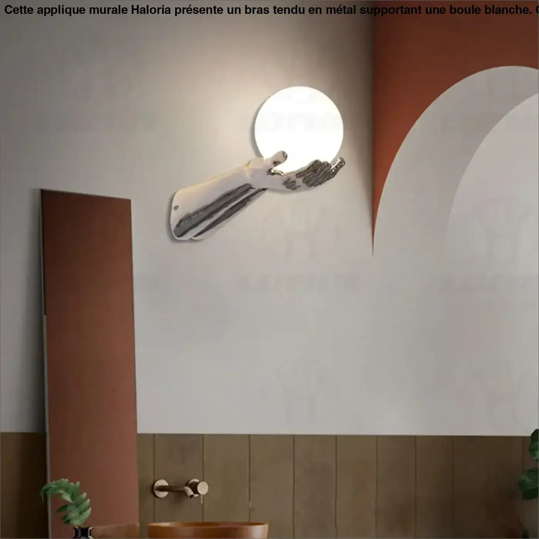 Applique murale avec brand tendu tenant une boule blanche


