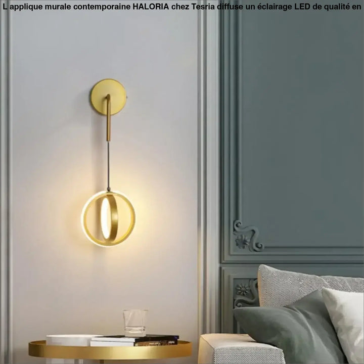 Applique murale contemporaine haloria en métal doré avec design circulaire minimaliste et éclairage ambiant chaud
