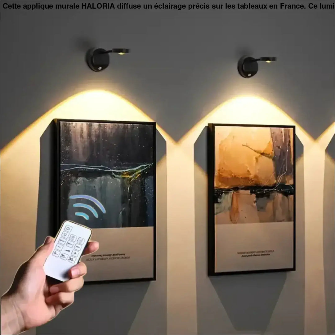 Applique murale eclairage haloria en spot noir avec têtes réglables illuminant des tableaux encadrés avec lumière chaude
