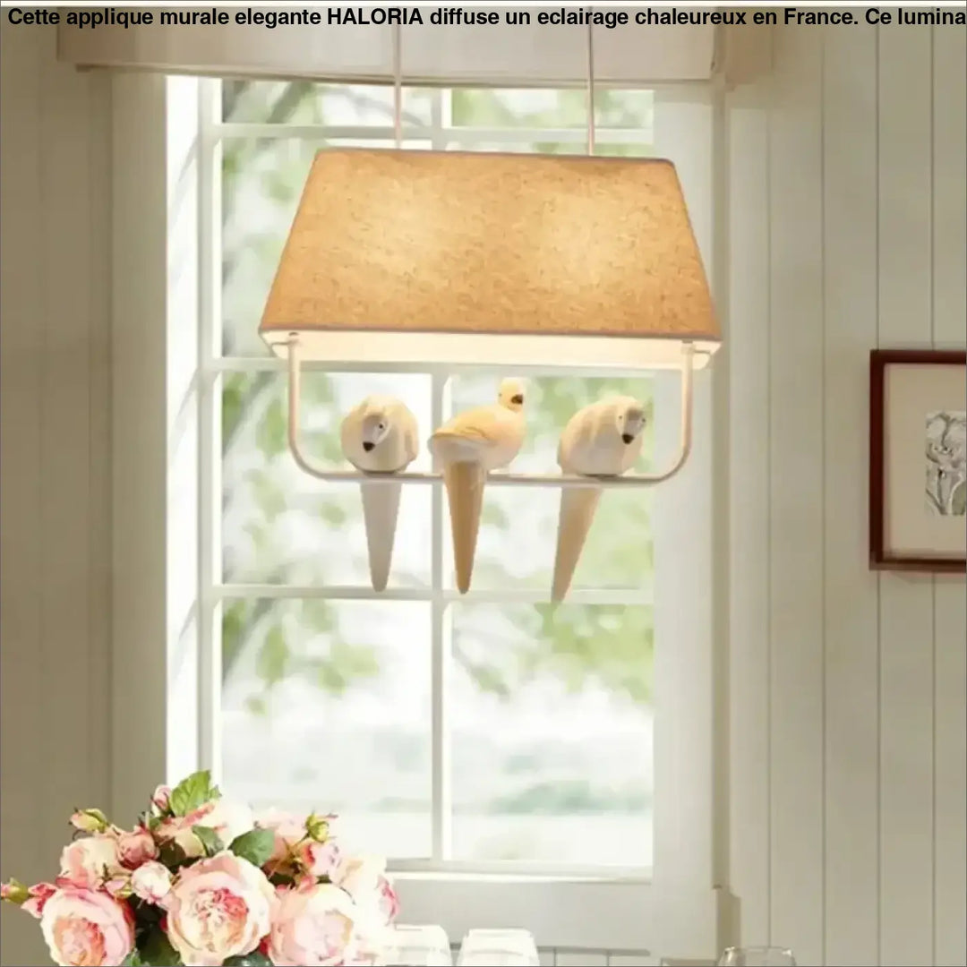 Suspension luminaire rectangulaire beige en liège avec trois oiseaux en céramique blanche perchés sur une structure métallique