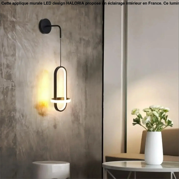Applique murale led design noire en métal moderne avec éclairage ambiant chaud et forme ovale allongée haloria