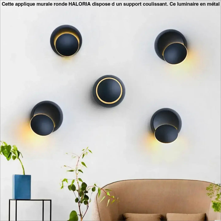 Applique murale ronde haloria en forme sphérique noire avec accents dorés émettant une lumière chaude et coulissante