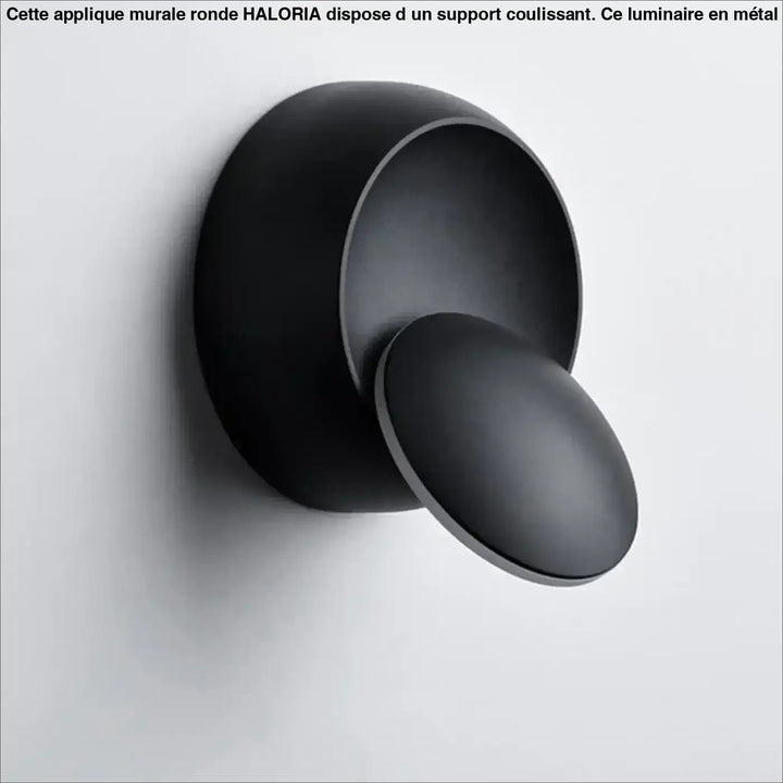 Matte black applique murale ronde with a sliding mount featuring a sleek minimalist design by haloria