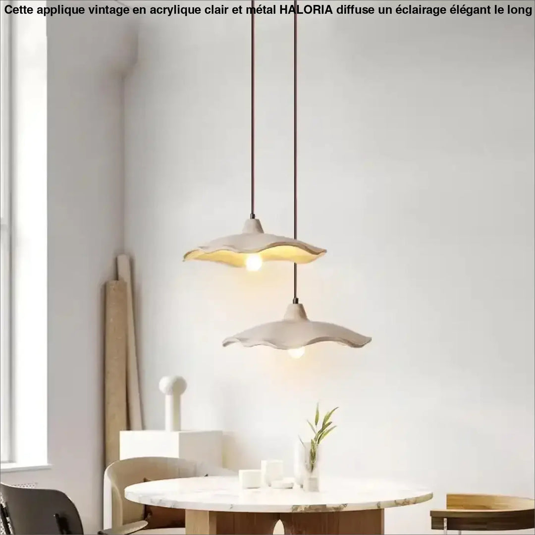 Deux appliques vintage en acrylique clair avec base en metal et bords festonnés suspendues au dessus d une table en marbre