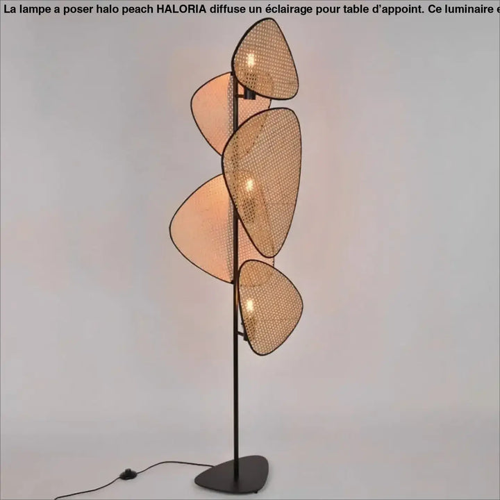 Lampadaire poser halo peach avec cinq abat-jours superposés en matériaux naturels tressés beige chaud et structure métal noir