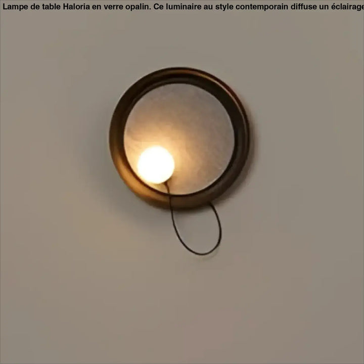 Applique murale contemporaine orluna en laiton rond avec miroir dépoli et cordon noir suspendu