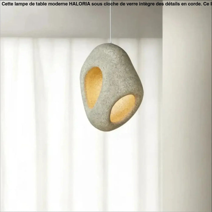 Suspension luminaire cavia en pierre grise texturée avec deux ouvertures circulaires à lumière chaude design luminaire aux