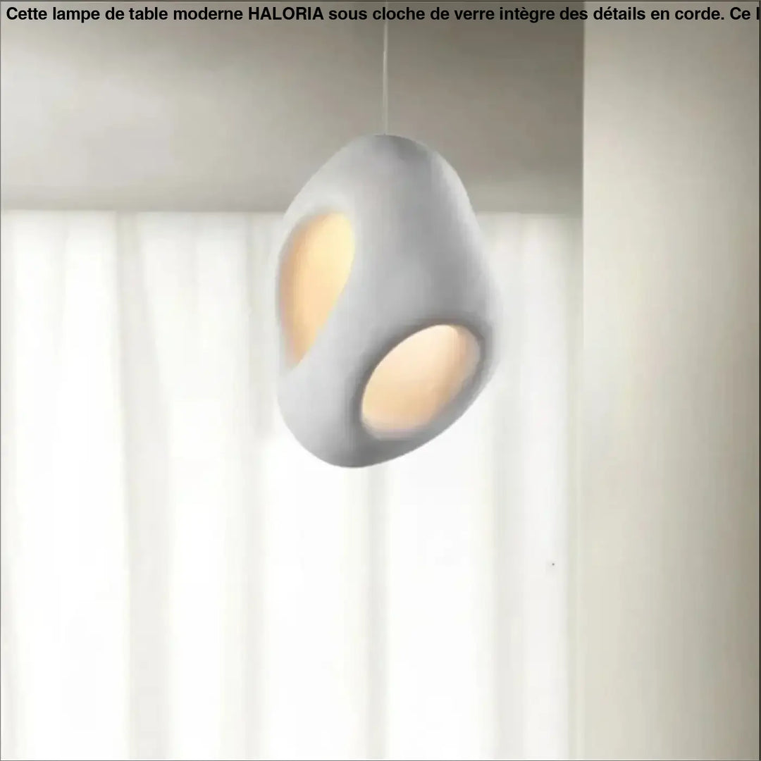 Suspension luminaire cavia en céramique mate grise avec deux découpes ovales diffusant une lumière chaude