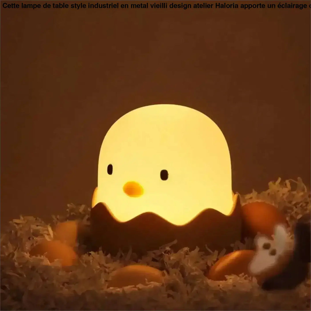 Veilleuse led douce ptibou en forme de poussin jaune lumineux dans une coquille dœuf marron