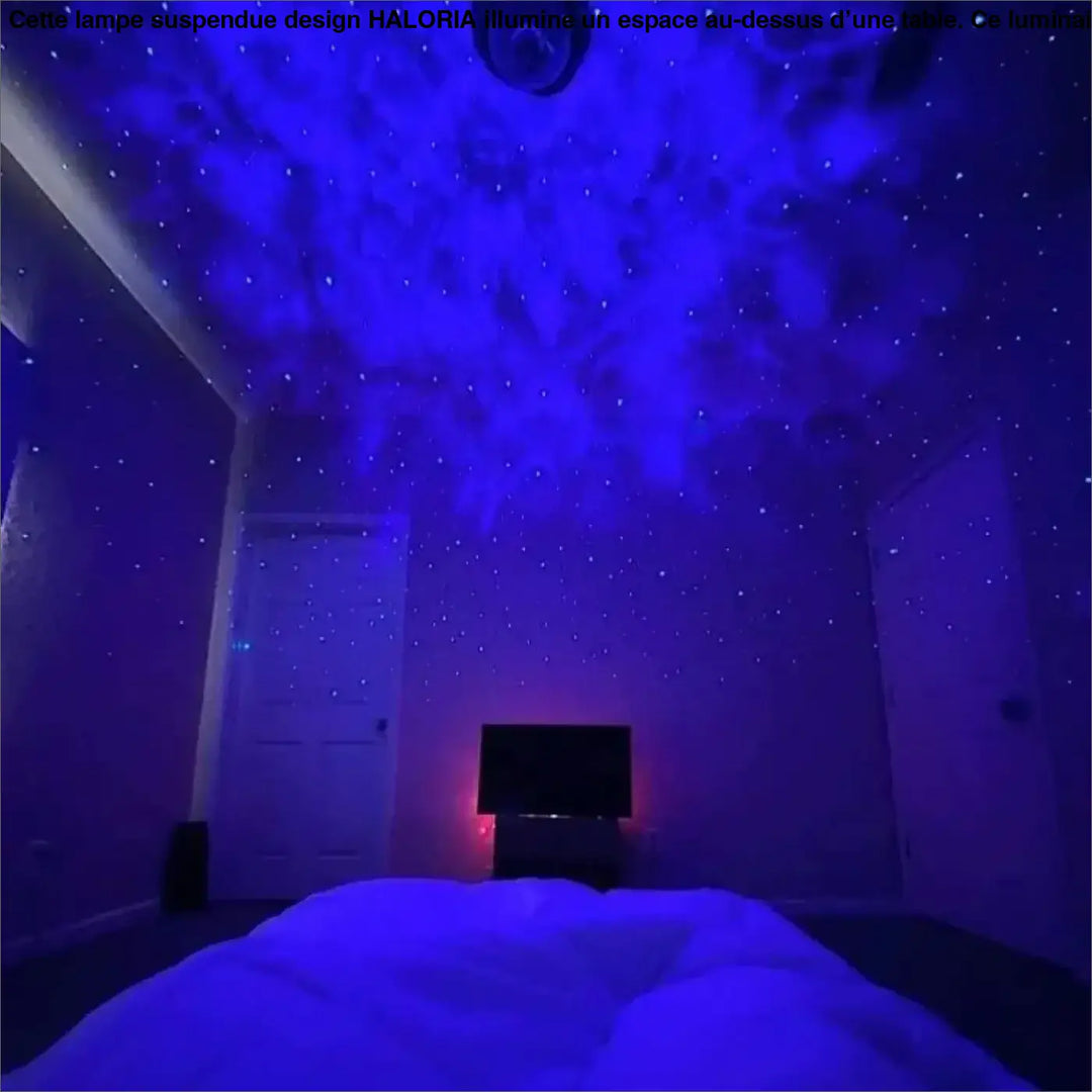 Lampe suspendue design haloria avec projecteur de plafond diffusant un effet ciel étoilé bleu profond dans la pièce