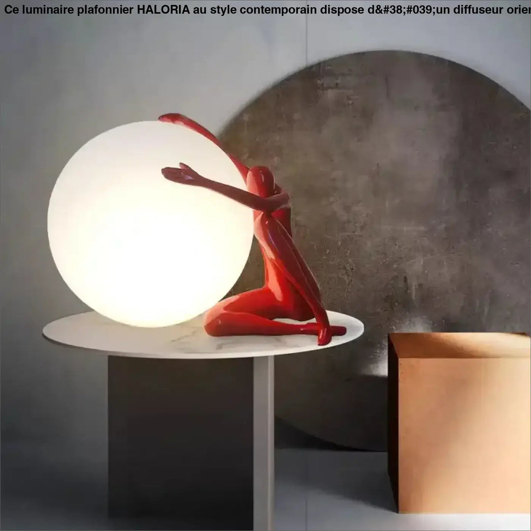 Lampe de table kelya en résine rouge brillant avec silhouette enlacée tenant une lumière sphérique blanche