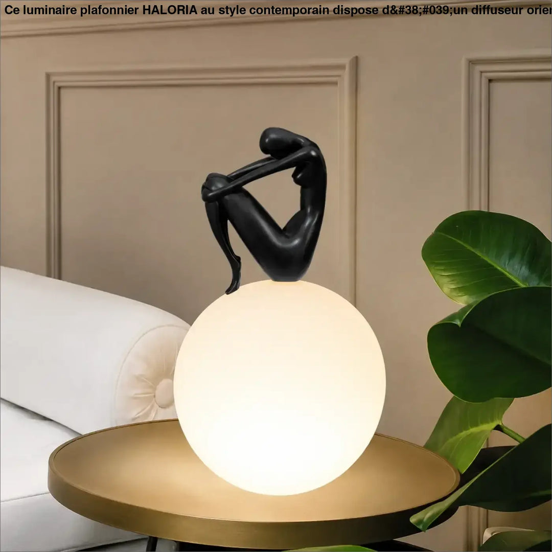 Lampe de table kelya avec silhouette enlacée noire perchée sur lumière sphérique pour un design de table contemporain