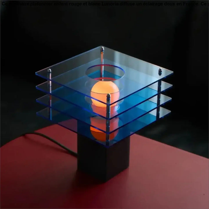 Lampe de chevet sunrise au design moderne avec base carrée en acrylique bleu translucide et orbe orange lumineux