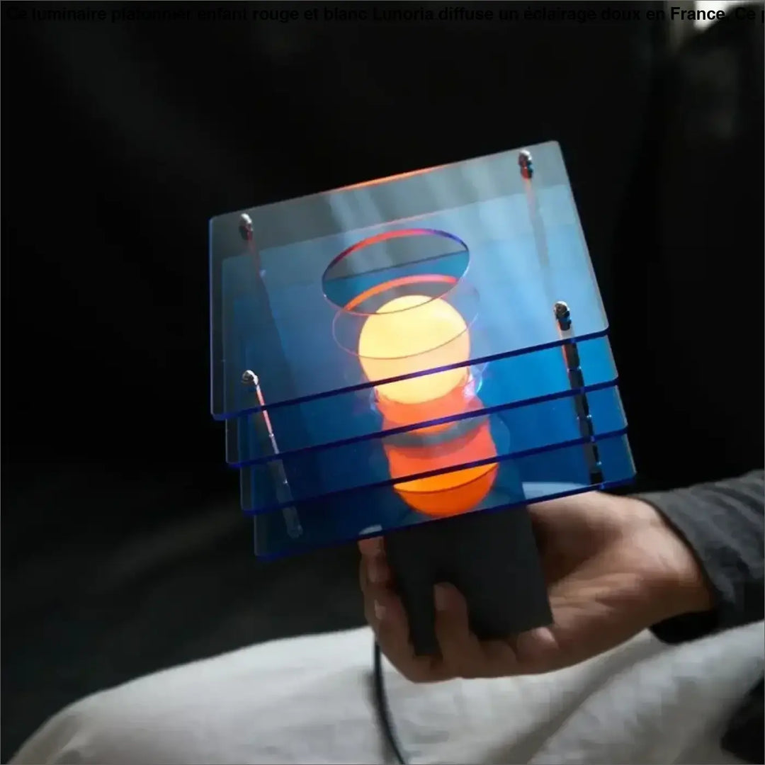 Lampe de chevet design moderne en acrylique bleu translucide avec une lueur orange chaude pour ambiance cosy