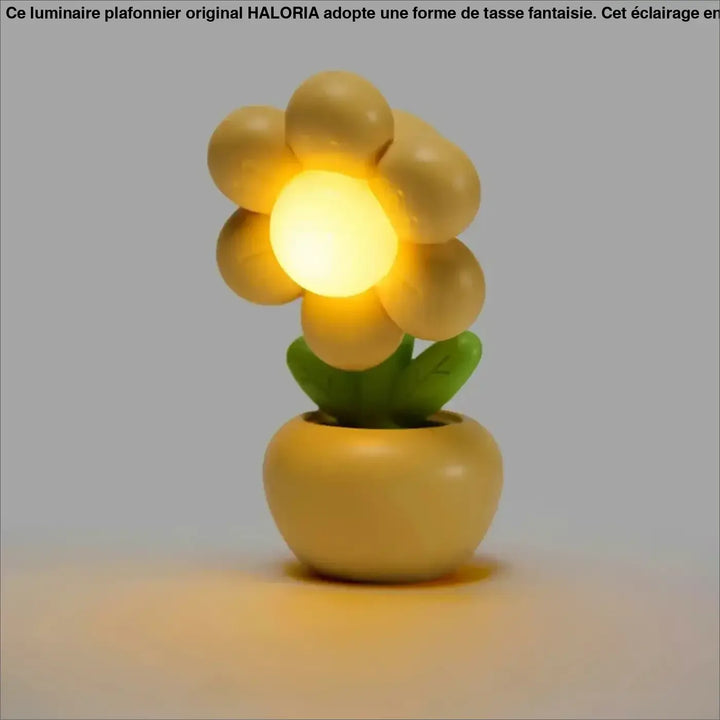 Veilleuse flow en forme de fleur jaune chaude avec lumière douce et objet décoratif dans pot assorti vert