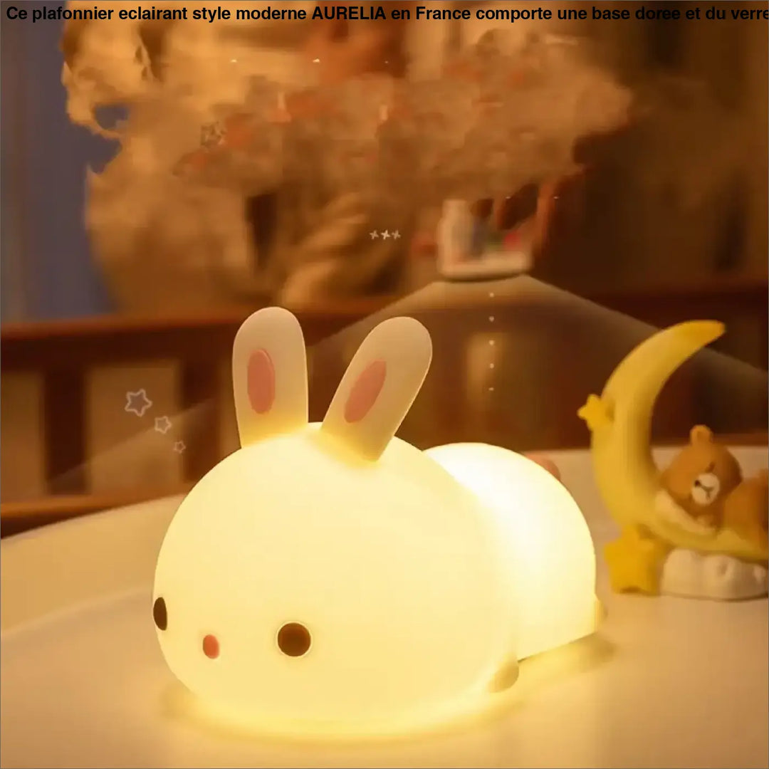 Veilleuse lapin souple blanche rabby avec oreilles roses et yeux noirs émettant une douce lumière sur une table
