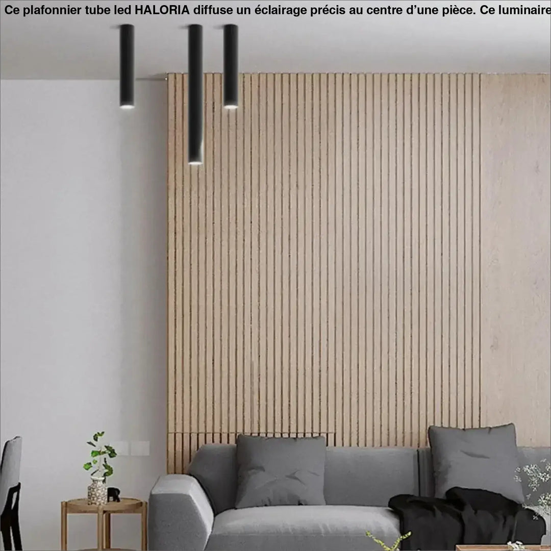 Trois plafonniers tube led noirs cylindriques suspendus au plafond modèle haloria