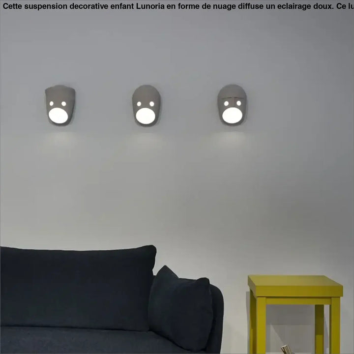 Trois suspensions decorative enfant lunoria en ceramique grise avec visage arrondi et lumiere blanche douce