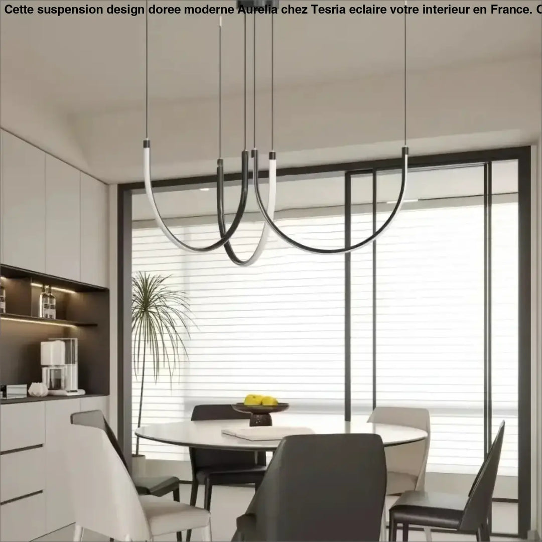 Suspension design doree moderne en noir et blanc avec luminaires courbes au-dessus d une table à manger