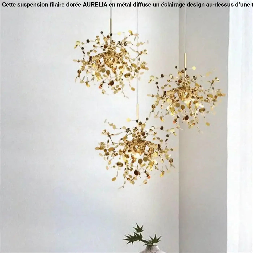 Suspension filaire dore aurelia avec trois suspensions dorées en forme de feuille, métal travaillé et accents circulaires pendants