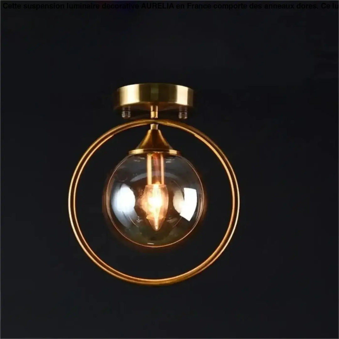 Plafonnier chic orbane en anneau doré avec boule lumineuse en verre clair et ampoule à filament visible
