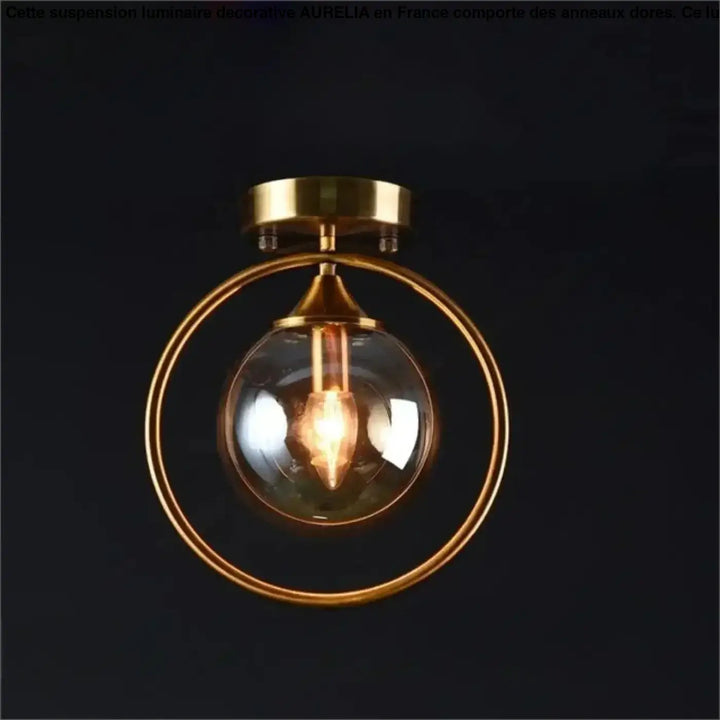 Plafonnier chic orbane en anneau doré avec boule lumineuse en verre clair et ampoule à filament visible