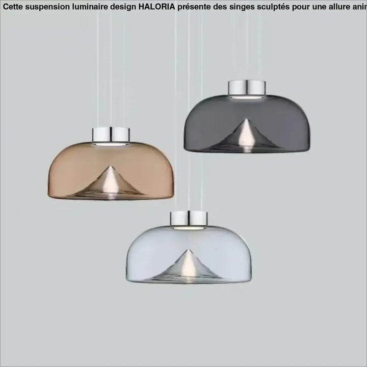 Suspension luminaire eclari avec trois abat-jours en verre transparent fumé ambre, gris et clair au design moderne