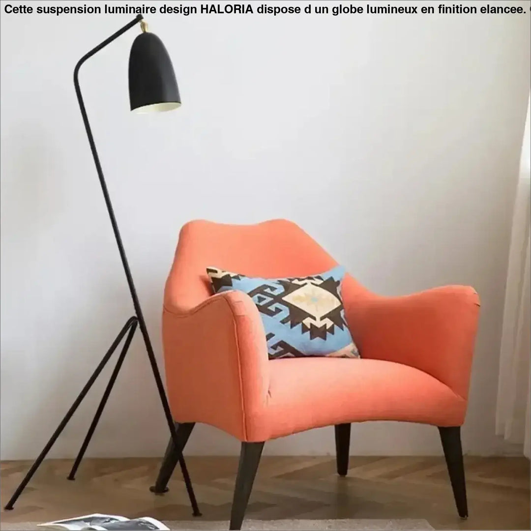 Orange armchair with geometric-patterned pillow highlighting lampadaire design minimaliste by trivio