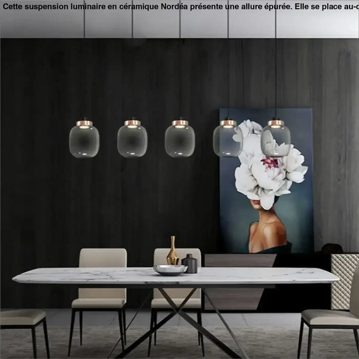 Suspension luminaire mistral avec cinq suspensions en verre gris fumé et accents en laiton au-dessus dune table en marbre