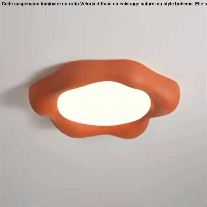 Luminaire plafonnier design nuage avec éclairage blanc doux au centre dans une forme asymétrique orange