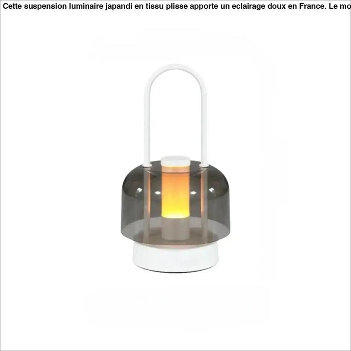 Lampe de table Cristo avec dôme gris translucide et base blanche émettant une douce lumière orange, idéal comme night light