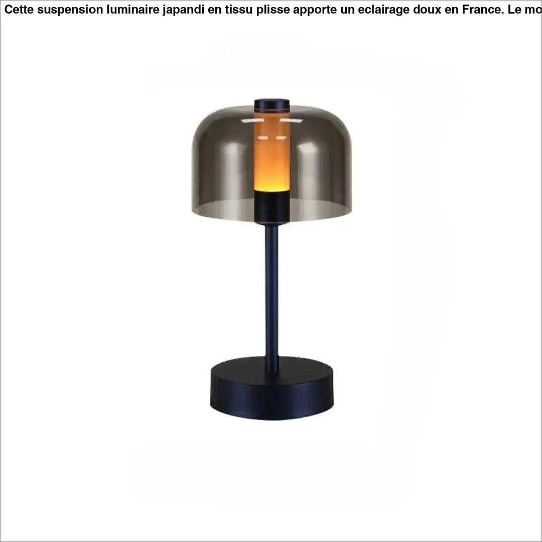 Lampe de table cristo avec base et tige en métal noir et dôme en verre fumé diffusant une lumière ambre chaude pour veilleuse