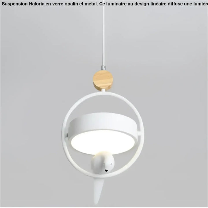 Suspension luminaire lineaire en verre opalin blanc avec cadre circulaire et oiseau décoratif au-dessus d’une table ou d’un coin salon