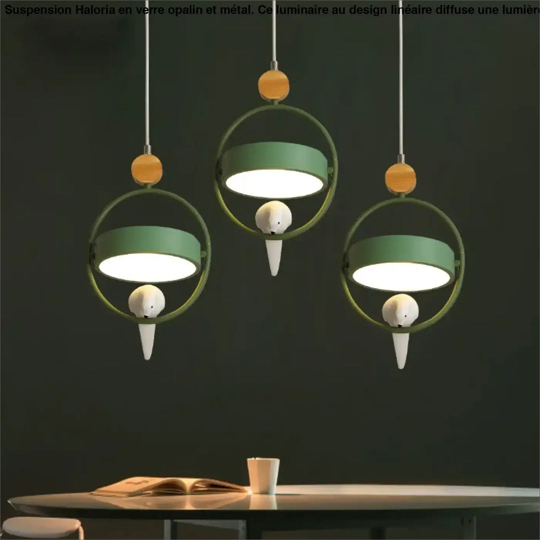 Suspension luminaire lineaire en verre opalin avec accents oiseaux blancs et details bois au-dessus d’une table