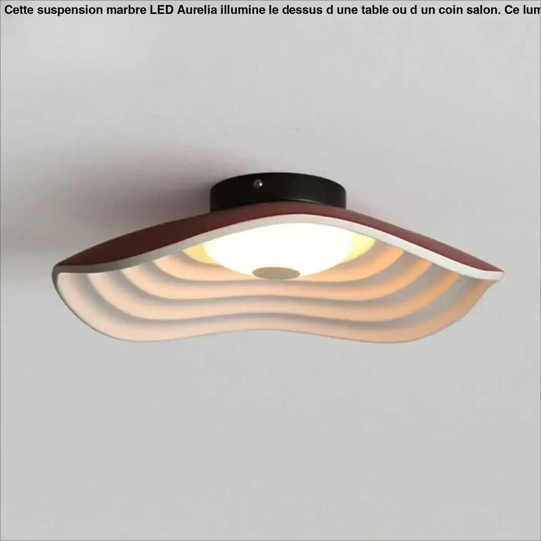 Suspension marbre led design elegant moderne aurelia au-dessus d’une table avec anneaux concentriques maron et blanc diffuse chaleur