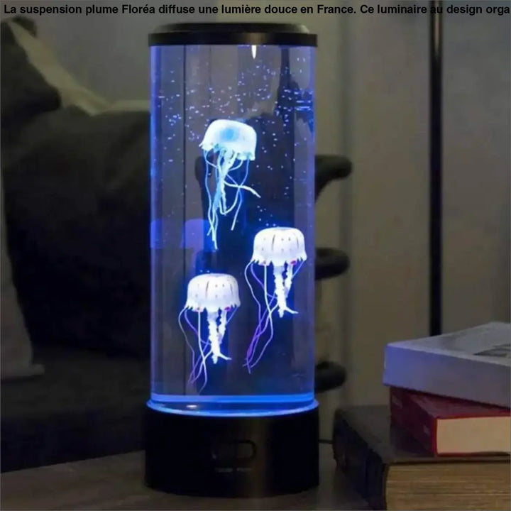 Suspension plume lampe aquarium cylindrique bleue au-dessus d’une table ou d’un coin salon avec base et dessus noirs